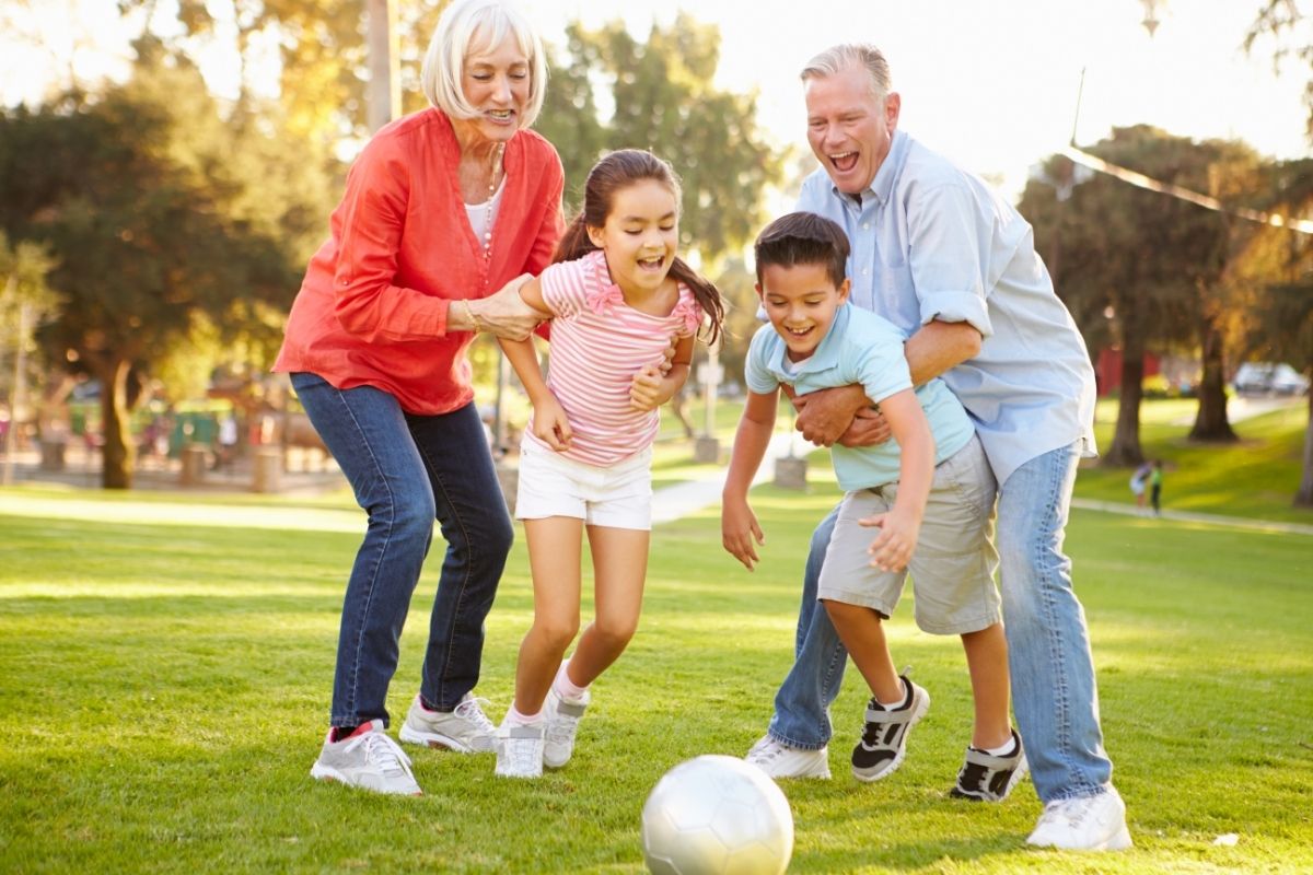 Grandparents and grandkids playing on the grass