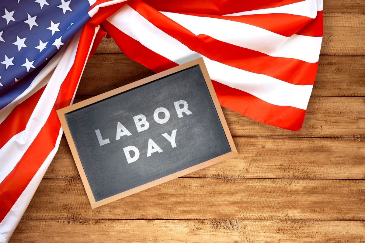 American flag on a table with a small chalkboard that reads labor day