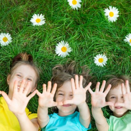 Kids on the grass with daisies